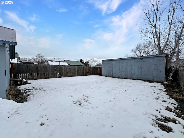 yard layered in snow with fence