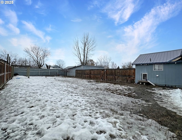 yard covered in snow featuring a fenced backyard