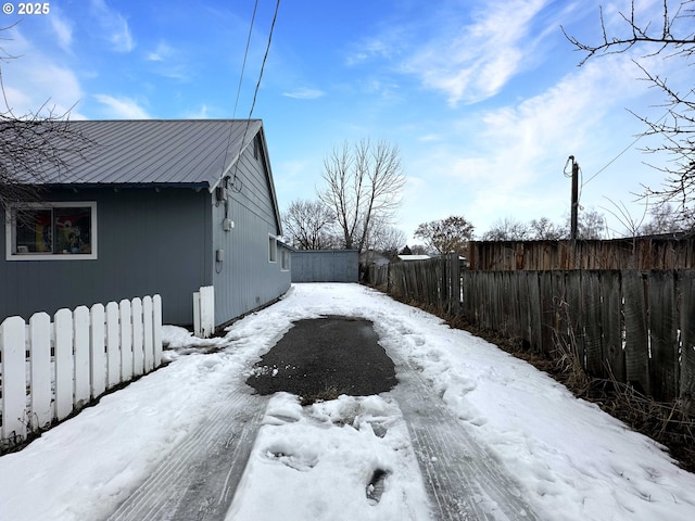 yard layered in snow with fence