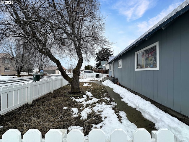 snowy yard with fence