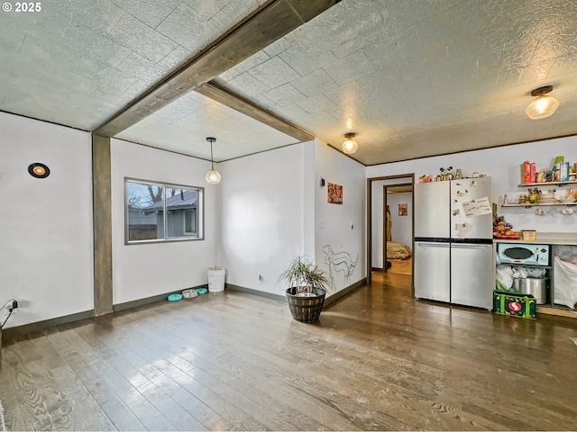 interior space featuring hardwood / wood-style floors and baseboards