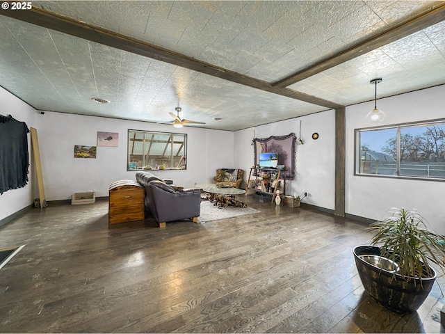 living area with hardwood / wood-style flooring, plenty of natural light, and baseboards