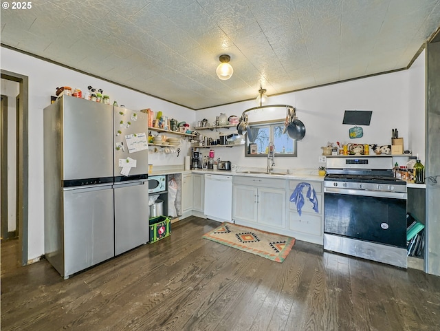 kitchen featuring a sink, white cabinets, light countertops, appliances with stainless steel finishes, and dark wood finished floors