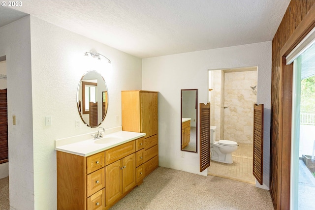 bathroom featuring vanity, walk in shower, a textured ceiling, and toilet