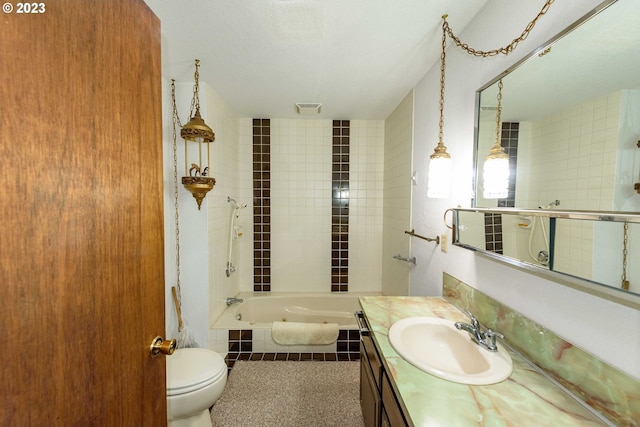 full bathroom featuring vanity, toilet, tiled shower / bath combo, and a textured ceiling