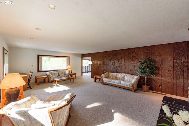 living room with carpet floors and wood walls