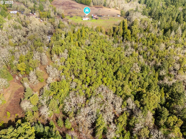 drone / aerial view featuring a wooded view