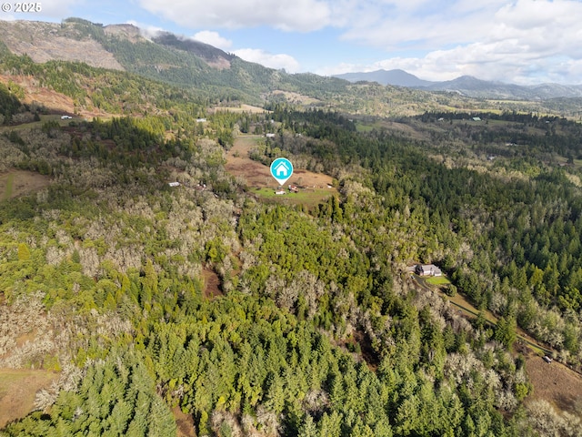 aerial view with a mountain view and a wooded view