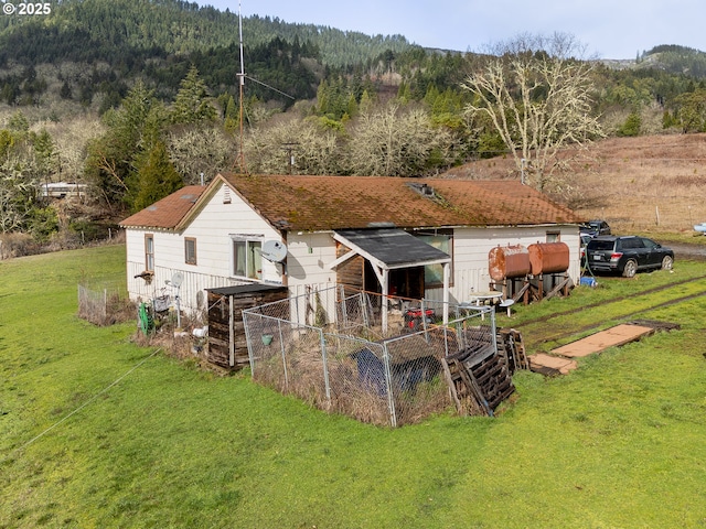 rear view of house with a yard