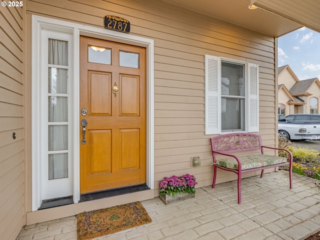 view of exterior entry with a porch