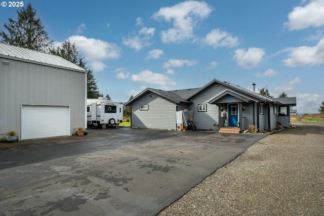 7655 Elliott St, Bay City, OR 97107 - view of front of house featuring entry steps, driveway, and an outdoor structure