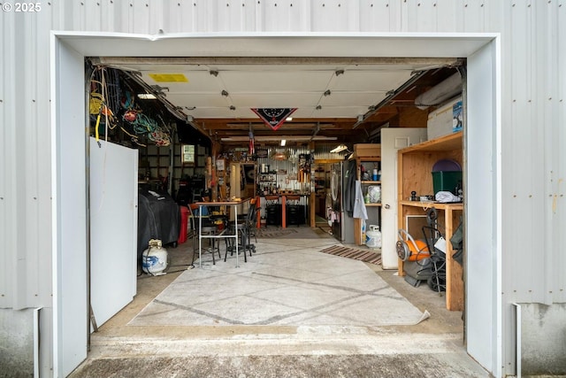 7655 Elliott St, Bay City, OR 97107 - garage featuring a workshop area and freestanding refrigerator