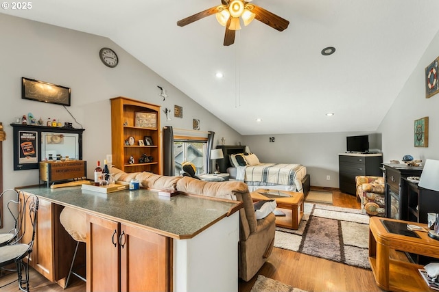 7655 Elliott St, Bay City, OR 97107 - living area with light wood-style flooring, a ceiling fan, and lofted ceiling