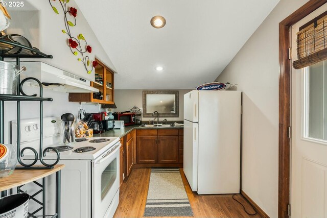 7655 Elliott St, Bay City, OR 97107 - kitchen featuring light wood-type flooring, white appliances, open shelves, brown cabinets, and a sink