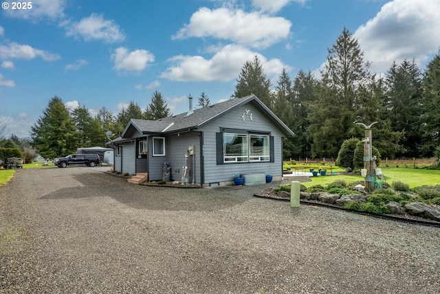 7655 Elliott St, Bay City, OR 97107 - exterior space with a shingled roof and a front lawn