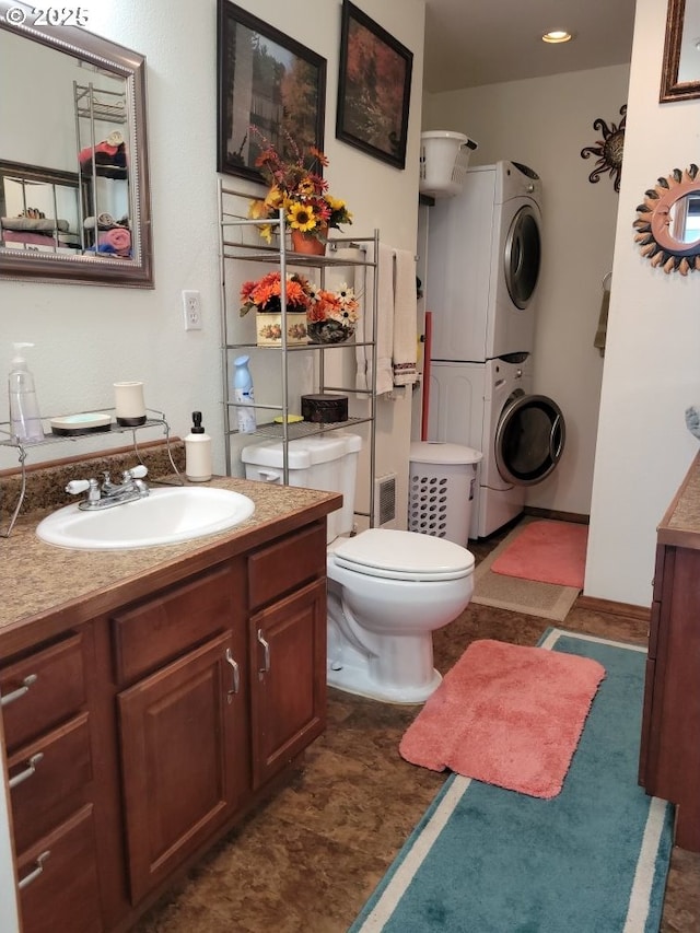 7655 Elliott St, Bay City, OR 97107 - bathroom with toilet, stacked washer and clothes dryer, and vanity