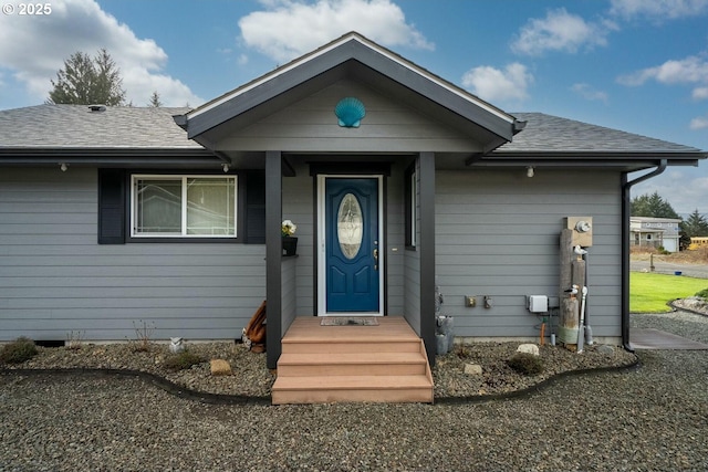 view of front of house featuring roof with shingles