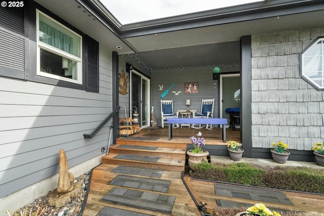 view of exterior entry with covered porch