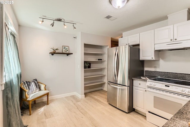 7573 N Edgewater Ave, Portland, OR 97203 - kitchen featuring electric stove, under cabinet range hood, freestanding refrigerator, light wood finished floors, and white cabinets