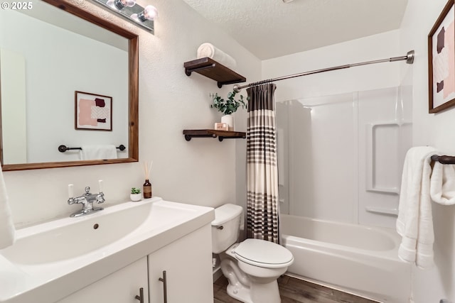 7573 N Edgewater Ave, Portland, OR 97203 - full bath with wood finished floors, toilet, shower / bathtub combination with curtain, vanity, and a textured ceiling
