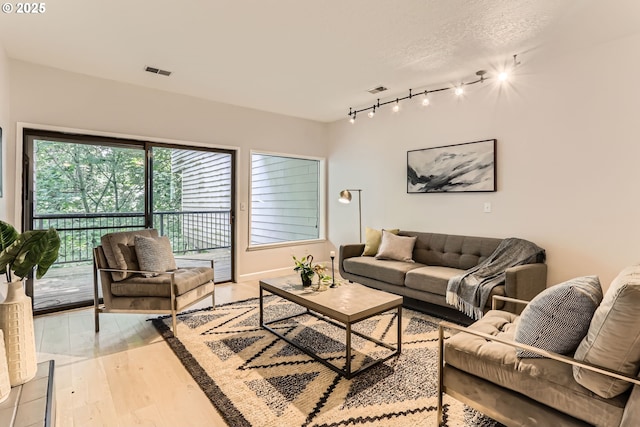 7573 N Edgewater Ave, Portland, OR 97203 - living room with light wood-type flooring and track lighting