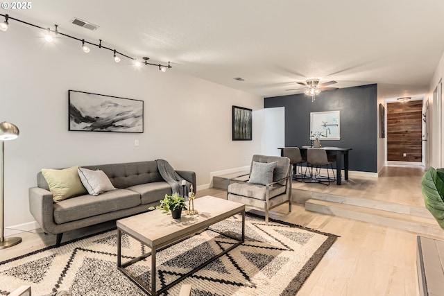 7573 N Edgewater Ave, Portland, OR 97203 - living room featuring baseboards, ceiling fan, and light wood-style floors
