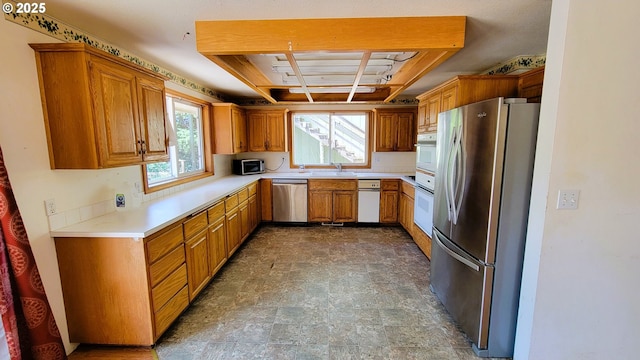 48495 Mcfarland Rd, Oakridge, OR 97463 - kitchen featuring stainless steel appliances, stone finish floors, light countertops, and plenty of natural light