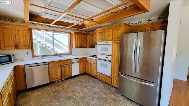 48495 Mcfarland Rd, Oakridge, OR 97463 - kitchen featuring appliances with stainless steel finishes, brown cabinets, and light countertops