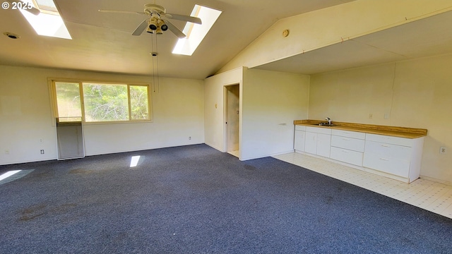 48495 Mcfarland Rd, Oakridge, OR 97463 - carpeted spare room with a skylight, vaulted ceiling, and a ceiling fan