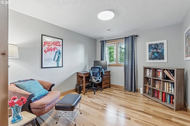 24601 SW 65th Ave, Tualatin, OR 97062 - home office with wood finished floors, a textured ceiling, and baseboards