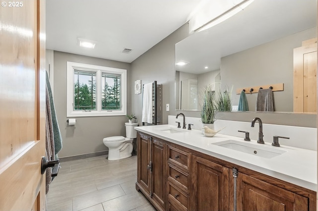 24601 SW 65th Ave, Tualatin, OR 97062 - bathroom featuring toilet, double vanity, tile patterned flooring, and baseboards