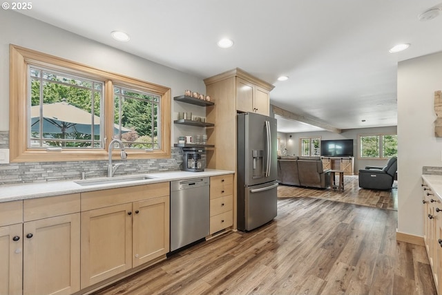 24601 SW 65th Ave, Tualatin, OR 97062 - kitchen featuring appliances with stainless steel finishes, a sink, light brown cabinetry, open floor plan, and light countertops