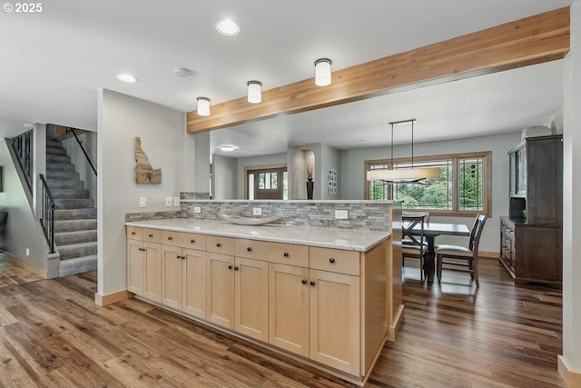 24601 SW 65th Ave, Tualatin, OR 97062 - kitchen with a peninsula, dark wood finished floors, recessed lighting, baseboards, and light stone counters