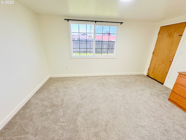 unfurnished bedroom featuring baseboards and carpet flooring