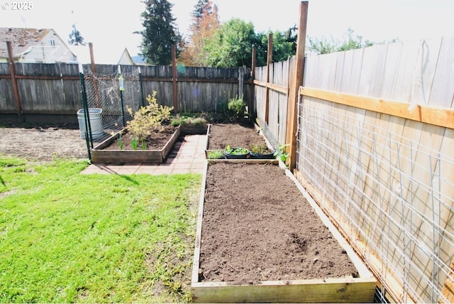 view of yard featuring a vegetable garden and a fenced backyard