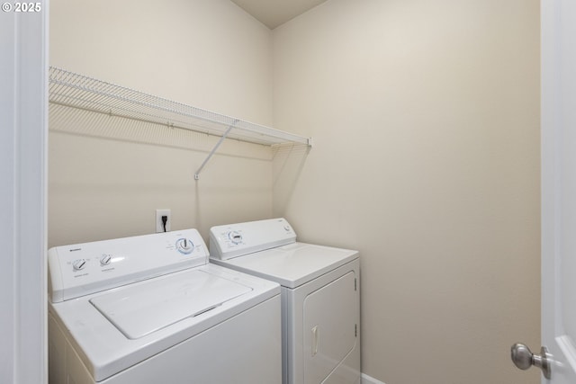 clothes washing area featuring independent washer and dryer