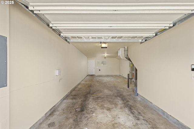 garage featuring a garage door opener and strapped water heater