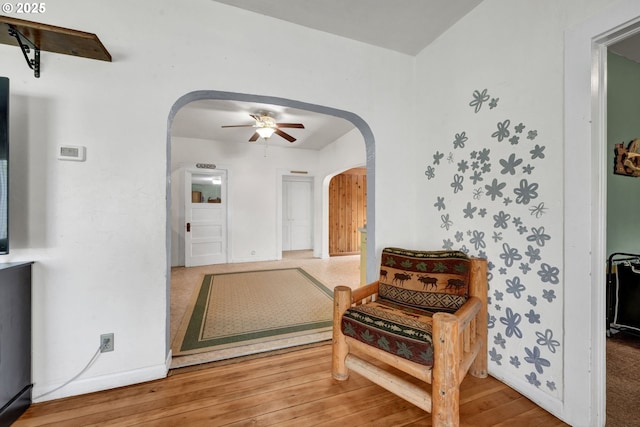 803 Main St, Philomath, OR 97370 - living area with arched walkways, ceiling fan, wood finished floors, and baseboards