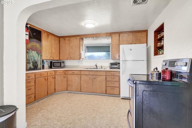 803 Main St, Philomath, OR 97370 - kitchen with electric range oven, freestanding refrigerator, a sink, stainless steel microwave, and light countertops