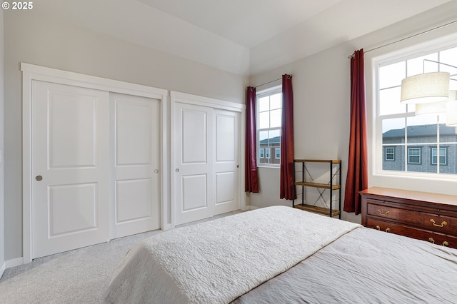 unfurnished bedroom with carpet and multiple closets