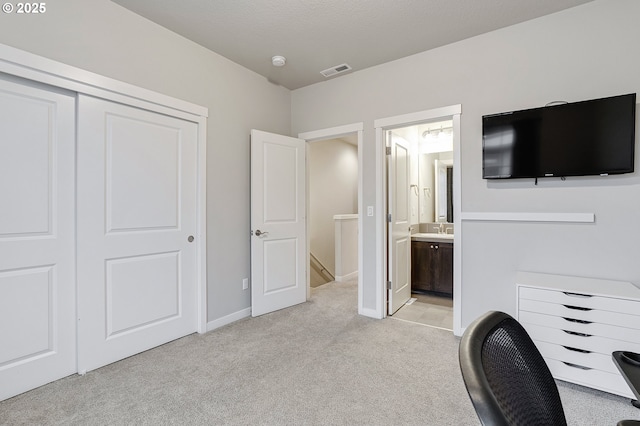 office with visible vents, light colored carpet, and baseboards