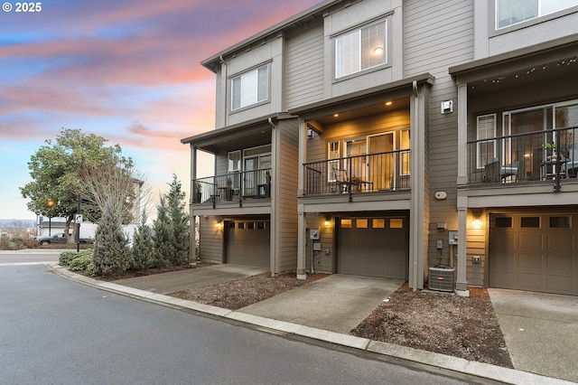 townhome / multi-family property featuring driveway and a garage