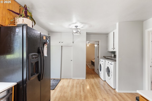 1175 Northside Rd, Sutherlin, OR 97479 - kitchen featuring black refrigerator with ice dispenser, washing machine and dryer, light wood-type flooring, white cabinetry, and a ceiling fan