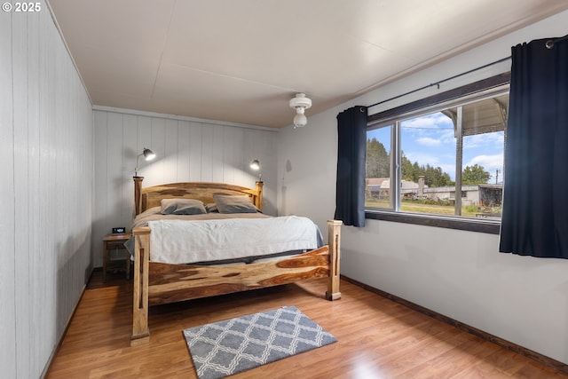 1175 Northside Rd, Sutherlin, OR 97479 - bedroom with baseboards, light wood-style flooring, and wood walls
