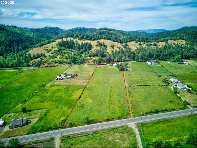 1175 Northside Rd, Sutherlin, OR 97479 - aerial view of sparsely populated area featuring property boundaries highlighted, a mountain backdrop, and a heavily wooded area