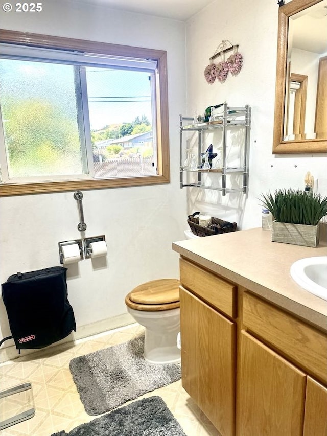 1021 Starlight St, The Dalles, OR 97058 - half bath with vanity, toilet, and tile patterned flooring