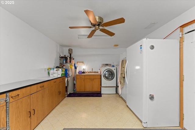 1021 Starlight St, The Dalles, OR 97058 - laundry room featuring washing machine and dryer, light flooring, a ceiling fan, and cabinet space