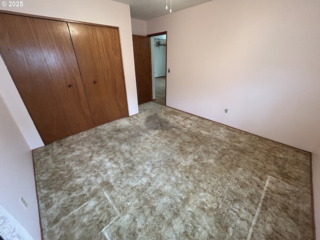 unfurnished bedroom featuring a closet and carpet floors