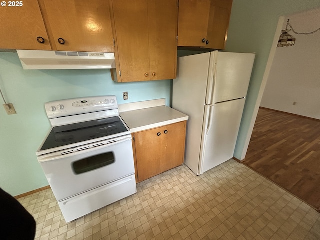 kitchen featuring white appliances, light floors, baseboards, light countertops, and under cabinet range hood