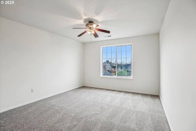 unfurnished room featuring light colored carpet and ceiling fan